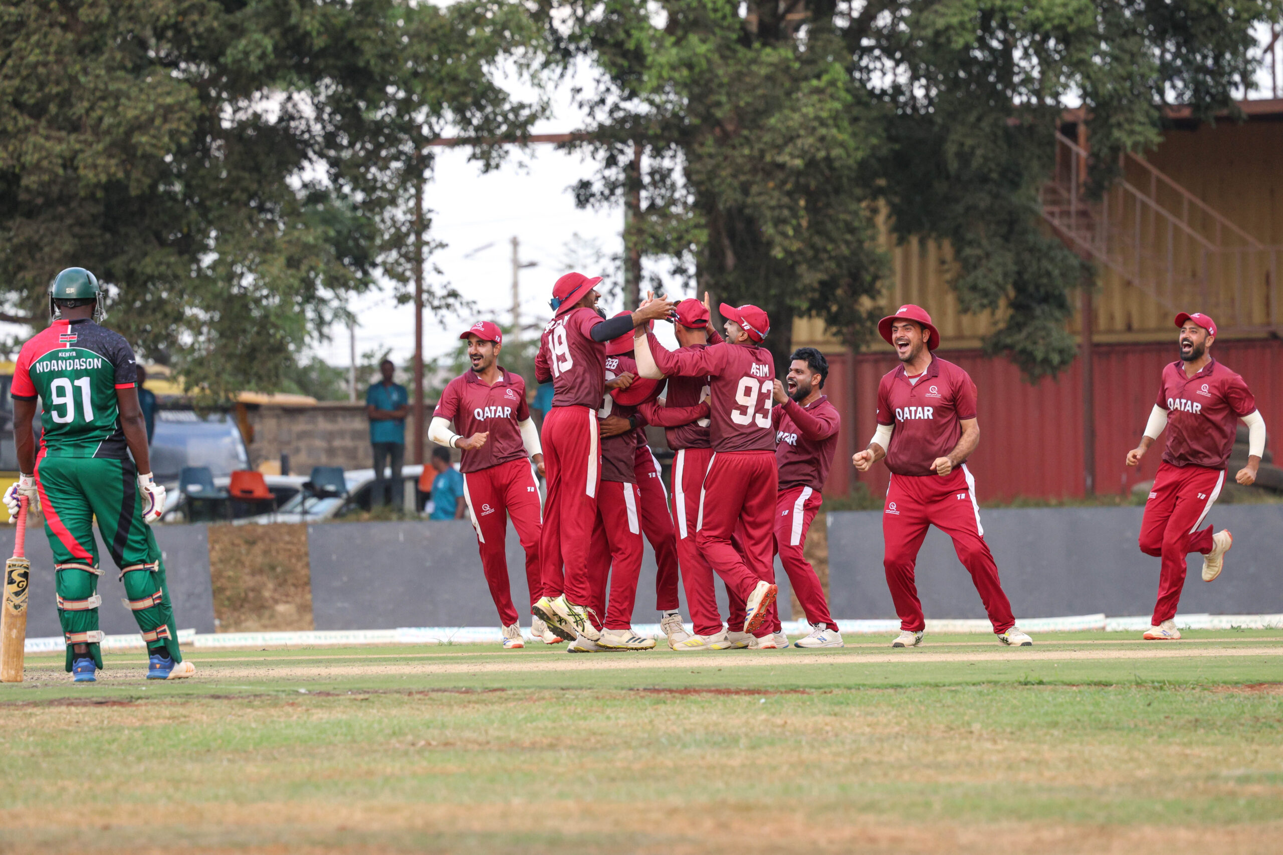 Qatar cricket players celebrate after taking a wicket against Kenya in the ICC CWC Challenge League A